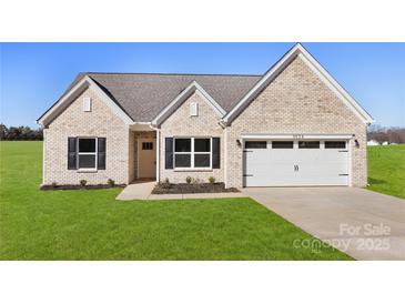 Brick house with 2-car garage and landscaped lawn at 3524 Cloninger Rd, Dallas, NC 28034