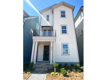 Charming two-story home with a covered porch and fresh landscaping at 425 Delburg Mill Alley Dr, Davidson, NC 28036