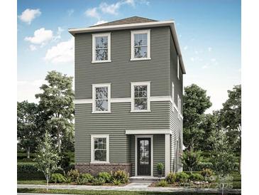 Three-story home with gray siding, white trim, and a brick base at 429 Delburg Mill Alley Dr, Davidson, NC 28036