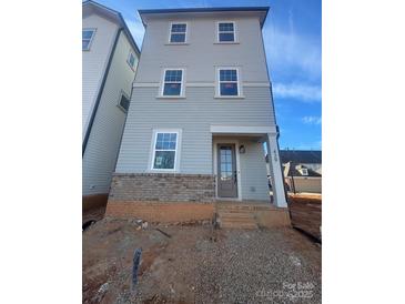 Three story home featuring beautiful blue siding and a brick foundation, steps to the covered front door at 429 Delburg Mill Alley Dr, Davidson, NC 28036