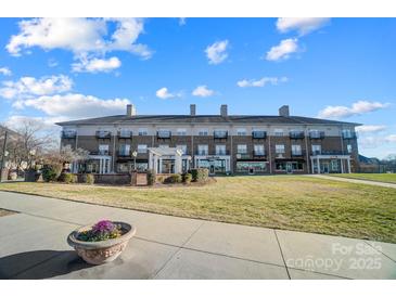 Brick building with commercial spaces and residential units at 5435 Village Nw Dr, Concord, NC 28027