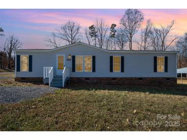 Nice manufactured home with a brick skirt and a spacious yard at 820 Bethesda Rd, Statesville, NC 28677