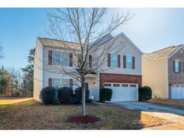 Two-story house with brick and siding, attached garage, and landscaping at 11906 Bending Branch Rd, Charlotte, NC 28227