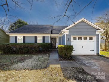 Charming ranch home with gray siding, white garage door, and landscaped lawn at 12813 Danby Rd, Indian Land, SC 29707