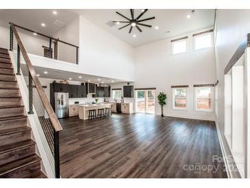 Open concept living area with kitchen, loft, and hardwood floors at 219 Mock Mill Rd, Statesville, NC 28677