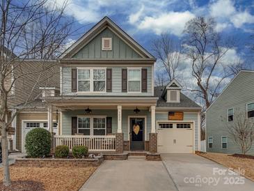 Charming two-story home with a cozy front porch and well-maintained landscaping at 3020 Graceland Cir # 11D, Pineville, NC 28134