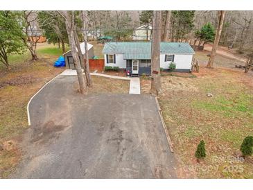 Aerial view of a charming house with a green roof and spacious yard at 3510 Oakwood Ave, Claremont, NC 28610