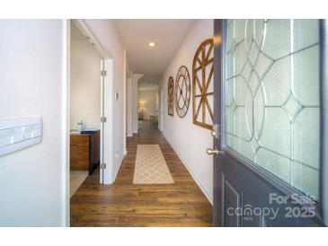 Bright hallway with hardwood floors and decorative wall accents at 3530 Hackberry Dr, Gastonia, NC 28056