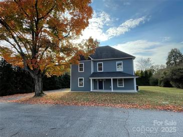 Two-story house with gray siding, front porch, and mature tree in the yard at 502 E 2Nd St, Salisbury, NC 28146