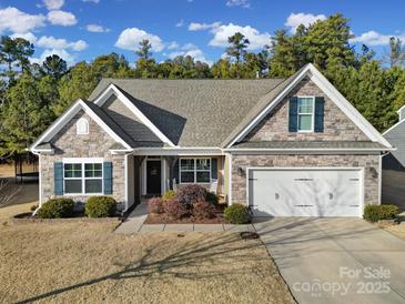 Inviting ranch home with stone accents and a two-car garage at 5803 Mcclintock Dr, Denver, NC 28037