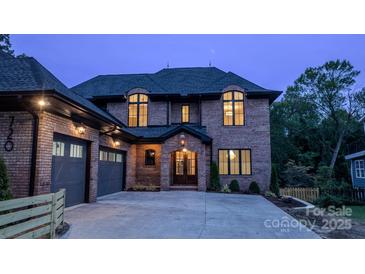 Brick two-story home with a two-car garage and a welcoming front porch at 720 Ideal Way, Charlotte, NC 28209