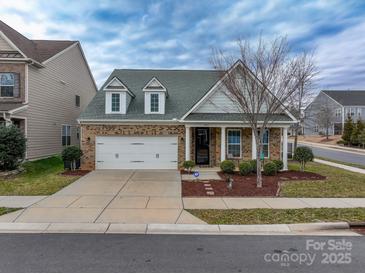 Brick front home with a two-car garage and landscaping at 867 Pecan Tree Ln, Fort Mill, SC 29715