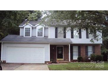 Two-story house with attached garage and landscaped lawn at 10006 White Cascade Dr, Charlotte, NC 28269