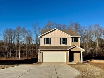 Two-story house with a two-car garage and a light brown exterior at 110 Oak Crossing Dr, Shelby, NC 28152