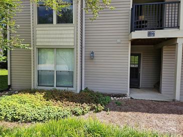 Condo with tan siding, well-maintained landscaping, and visible unit numbers at 11041 Cedar View Rd, Charlotte, NC 28226