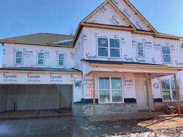 Two-story new home with gray siding, brick accents, and a two-car garage at 146 Nicholson Ln, Mooresville, NC 28115