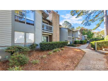 Exterior view of a condo building with walkway and landscaping at 5020 Sardis Rd # I, Charlotte, NC 28270