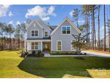 Two-story home with gray siding, stone accents, and a landscaped lawn at 0000 Crown Ter, Hickory, NC 28601