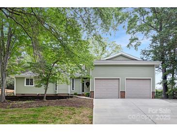 Charming home with a two-car garage, well-maintained lawn and an inviting front entrance at 10912 Treebark Dr, Charlotte, NC 28226