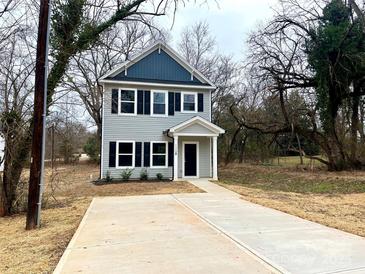 New two-story home with gray siding, dark trim, and a paved driveway at 129 Sharon Rd, York, SC 29745