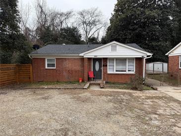 Brick ranch home with a fenced yard at 1401 Lasalle St, Charlotte, NC 28216