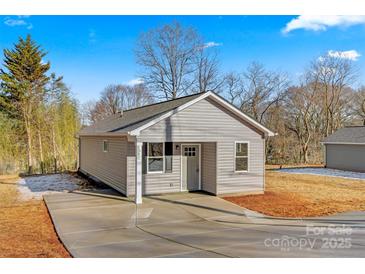 Newly constructed gray house with a concrete driveway at 1443 Southwest Blvd, Newton, NC 28658