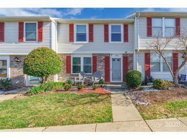 Brick townhouse with red shutters, front porch, and landscaping at 182 Water Oak Dr, Pineville, NC 28134