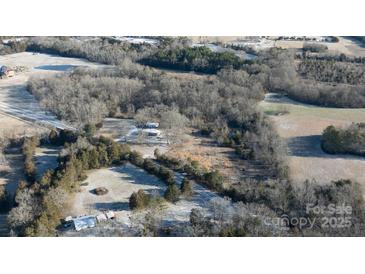 An aerial view of the property showing the home, surrounding trees, and the nearby road at 3374 Skyline Rd, Rock Hill, SC 20730