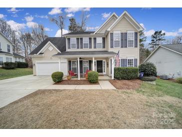 Two-story house with a covered porch, two-car garage, and manicured lawn at 3812 Leela Palace Way, Fort Mill, SC 29708