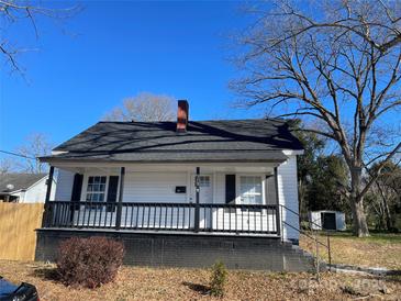 White house with front porch, mature trees, and a detached shed at 518 W White St, Chester, SC 29706