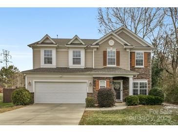 Two-story house with stone accents and a landscaped yard at 7845 Kuck Rd, Mint Hill, NC 28227