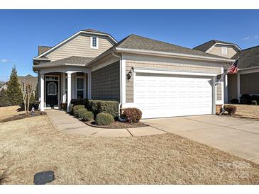 House exterior featuring a two-car garage and well-manicured lawn at 8024 Carolina Lakes Way, Fort Mill, SC 29707