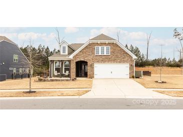 Inviting ranch home with stone accents and a two-car garage at 9009 Powder Works Dr, Huntersville, NC 28078