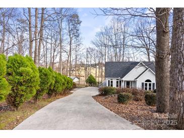 Charming home featuring a long driveway lined with trees and lush greenery at 926 Lone Oak Ln, Mooresville, NC 28115