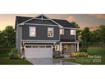 Two-story home with gray siding, white garage door, and landscaping at Lot 26 Winged Way, Kannapolis, NC 28083