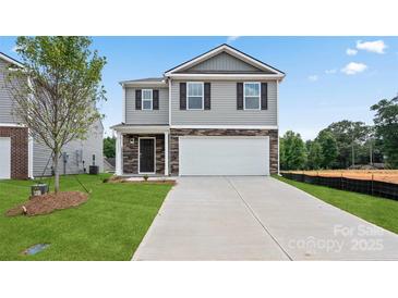 Two-story house with gray siding, stone accents, and a two-car garage at 1020 20Th Avenue Se Way, Hickory, NC 28602