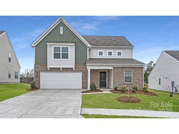 Two-story home with a two car garage, brick and siding exterior, and a well-manicured front lawn at 1175 Blackburn Cir, Edgemoor, SC 29712