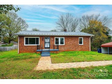 Brick ranch house with landscaped yard and walkway at 2752 21St Ne St, Hickory, NC 28601