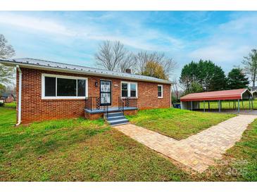 Brick ranch house with a landscaped yard and a carport at 2752 21St Ne St, Hickory, NC 28601