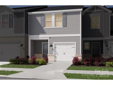 Gray two-story townhome with white garage door and landscaping at 5054 Kellaher Pl, Charlotte, NC 28216