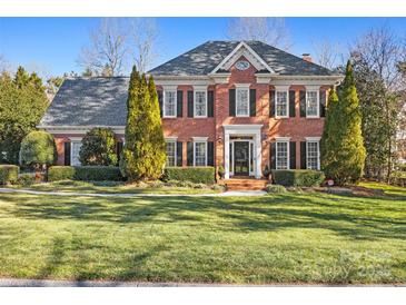 Brick two-story house with shutters, landscaping, and a large front yard at 6328 County Donegal Ct, Charlotte, NC 28277