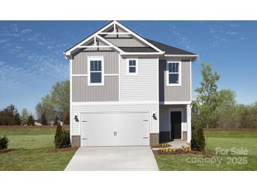 Two-story home with gray siding, white garage door, and landscaping at 821 Blue Canyon Dr, York, SC 29745