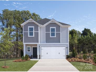 Two-story house with gray and white siding, a white garage door, and a landscaped lawn at 841 Blue Canyon Dr, York, SC 29745