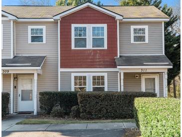 Modern two-story townhome with red accents and well-manicured landscaping at 311 Drury Dr, Charlotte, NC 28206