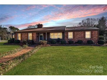 Charming brick home with a manicured lawn and inviting entrance, perfect for a cozy Gathering lifestyle at 401 Kenwood Ave, Cherryville, NC 28021