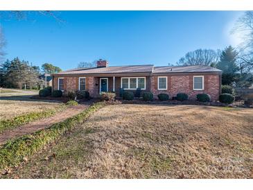 Brick ranch house with a landscaped yard and walkway at 401 Kenwood Ave, Cherryville, NC 28021