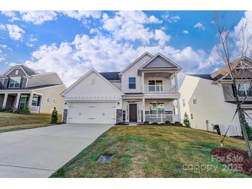 Two-story house with white siding, stone accents, and a two-car garage at 5036 Heathland Dr # 71, Charlotte, NC 28215