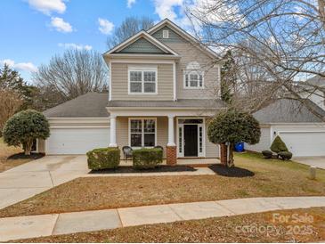 Two-story house with attached garage and landscaping at 7620 Rolling Meadows Ln, Huntersville, NC 28078