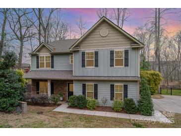 Charming two-story home featuring a mix of siding, brick, and tasteful landscaping at 9230 Windygap Rd, Charlotte, NC 28278