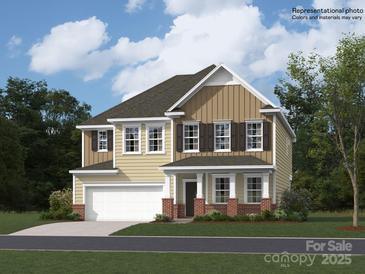 Two-story house with a two-car garage and a landscaped lawn at 149 Dogwood Grove Pl, Troutman, NC 28166